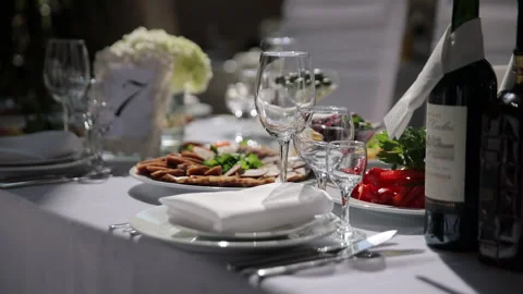 Elegant Table Setting: Perfectly Presented Table with Glassware and Delicious Stock Footage 231402952