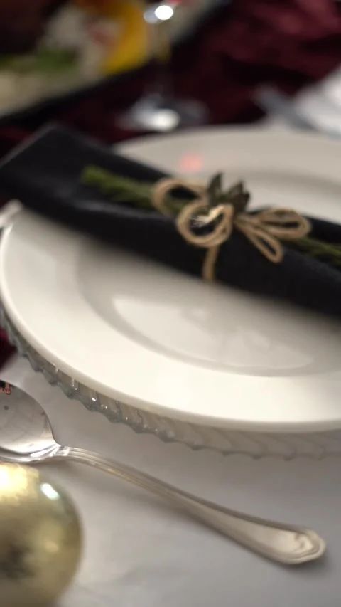 An elegant table setting with a plate and a wrapped napkin tied with string Stock Footage 333714606