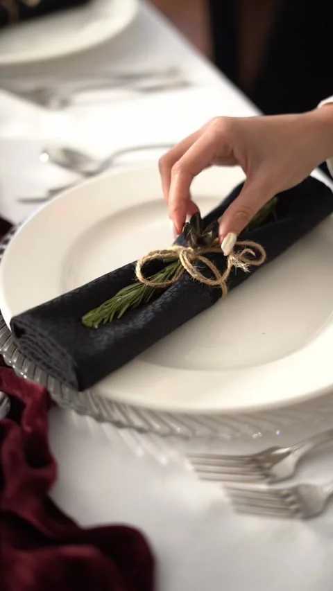 An elegant table setting with a plate and a wrapped napkin tied with string Stock Footage 333824017
