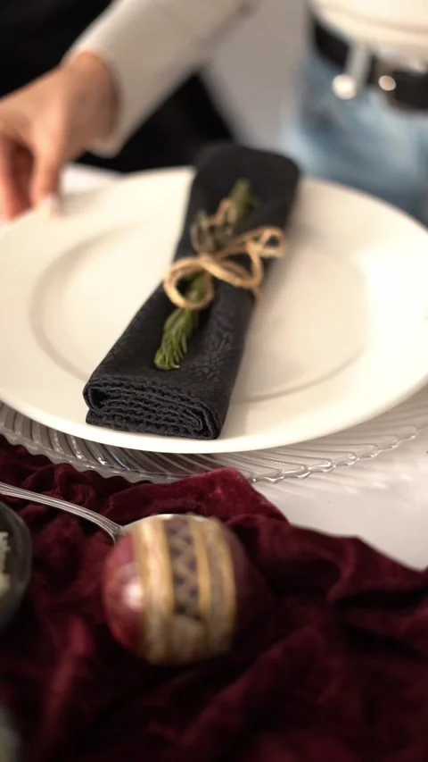 An elegant table setting with a plate and a wrapped napkin tied with string Stock Footage 334315532