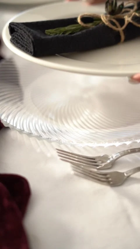 An elegant table setting with a plate and a wrapped napkin tied with string Stock Footage 334344777