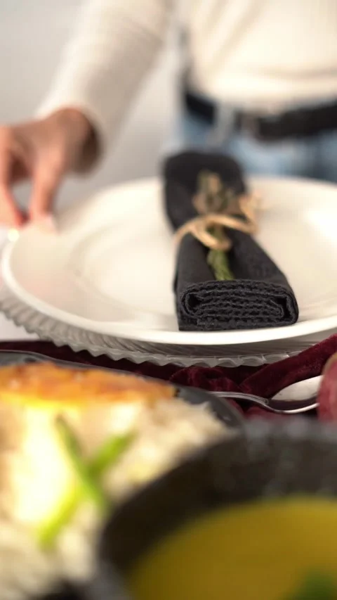 An elegant table setting with a plate and a wrapped napkin tied with string Stock Footage 334974756