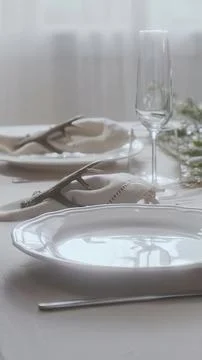 Elegant table setting with plates glassware and napkins Stock Photos