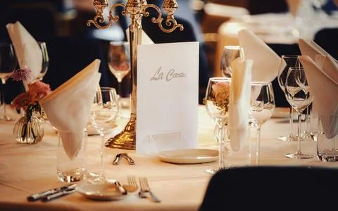 Elegant Table Setting Ready for Dining With Menu and Candlestick Stock Photos