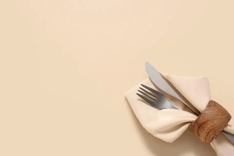 Elegant table setting with silverware and napkin ring on neutral background f Stock Photos