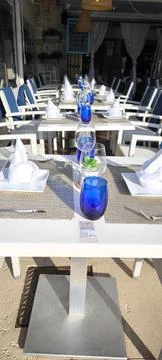 Elegant table setting in a summer cafe with blue accents Stock Photos
