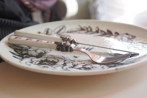 Elegant table setting with unique fork and floral plate Stock Photos