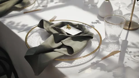 Elegant table setting with a white plate on a white tablecloth at a wedding and Stock Footage 307924604