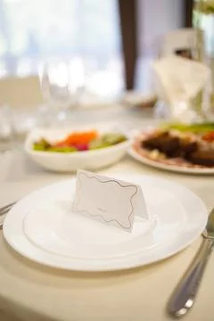 Elegant table setting with a white plate, cutlery and a card reading TABLE 1  Stock Photos