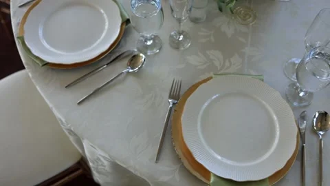 Elegant table setting with white plates and glasses Stock Footage 337910828