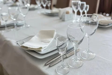 Elegant table setting with wine glasses and napkins Stock Photos