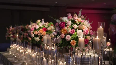 Elegant Table Setup with Colorful Flowers and Lit Candles for a Formal Event Stock Footage 296686612