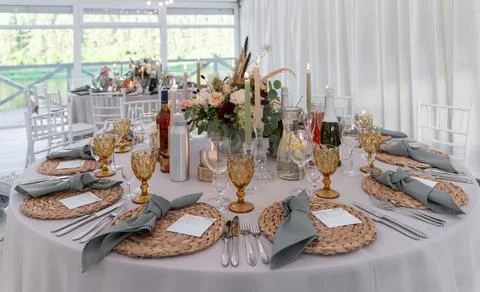 Elegant Table Setup at Wedding Reception with Candles and Floral Centerpiece Stock Photos