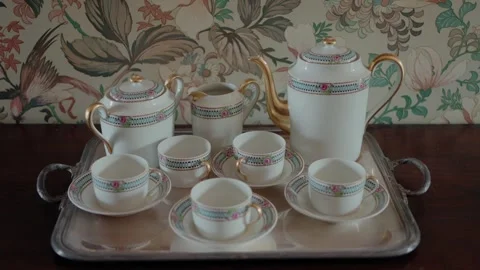 Elegant tea set with intricate patterns on a silver tray. Stock Footage 277069328