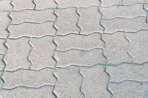Elegant Texture of Interlocking Concrete Pavers in Soft Morning Light Stock Photos