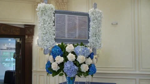 An Elegant Torah Scroll Display Featuring Beautiful Floral Decoration for Any Stock Footage 295007972