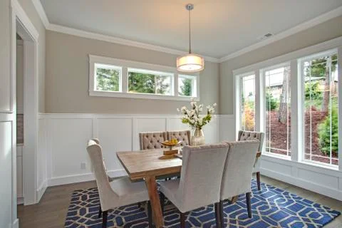 Elegant transitional dining room with board and batten walls, wood dining tab Stock Photos