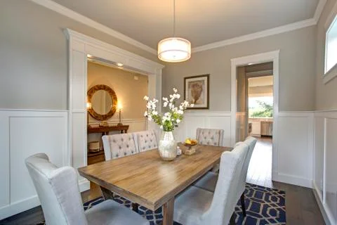 Elegant transitional dining room with board and batten walls, wood dining tab Stock Photos