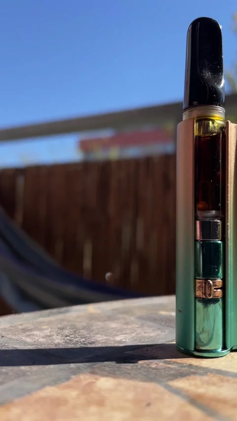 Elegant vaporizer featuring metallic gradient case and glossy black mouthpiece Stock Footage 341672158