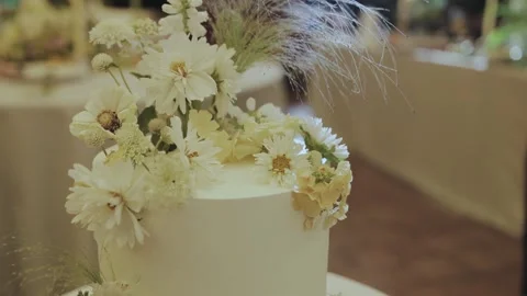 An Elegant Wedding Cake Skillfully Decorated with Beautiful White Flowers for Stock Footage 307918142