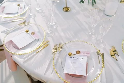 Elegant wedding dinner table setting with gold accents Stock Photos