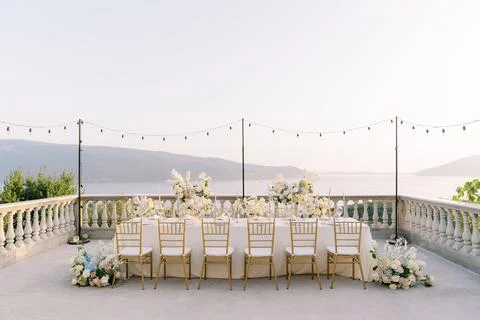 Elegant wedding dinner table at sunset by the sea Stock Photos