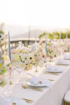 Elegant wedding dinner table at sunset by the sea Stock Photos