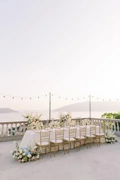 Elegant wedding dinner table at sunset by the sea Stock Photos