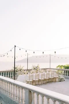 Elegant wedding dinner table at sunset by the sea Stock Photos