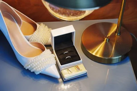 Elegant wedding essentials displayed on a bedside table with stylish lighting Stock Photos