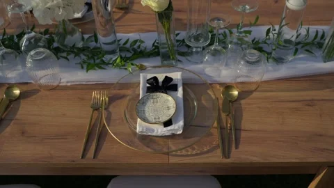 Elegant Wedding Place Setting With Gold Cutlery And Black Velvet Bow Stock Footage 340595628