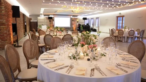 Elegant Wedding Reception Hall Decorated With Flowers and Candlelit Tables Stock Footage 336747710