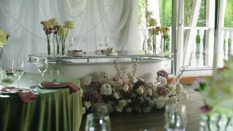 Elegant wedding reception table adorned with floral arrangements and glassware Stock Footage 339458667