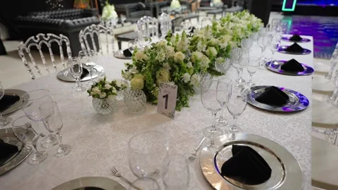 Elegant wedding reception table with beautiful floral centerpiece and number 스톡 동영상 332621103