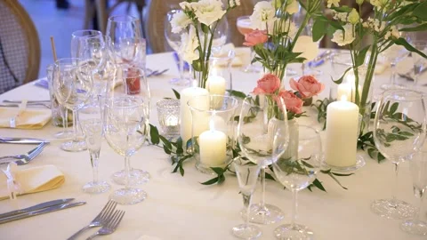 Elegant Wedding Reception Table with Candlelight, Flowers, and Crystal Glassware Stock Footage 336320432
