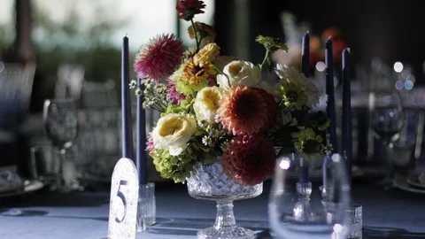 Elegant wedding reception table centerpiece with colorful fresh flowers in Stock Footage 337663293