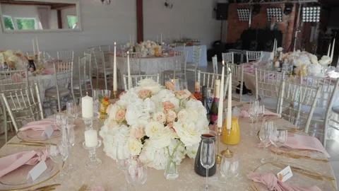 Elegant Wedding Reception Table Decor with Floral Centerpieces and Candlelight Stock Footage 339202384
