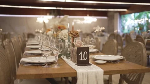 Elegant wedding reception table setting with flowers candles and table number Stock Footage 333021990