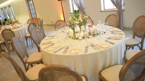 Elegant Wedding Reception Table Setting With Floral Centerpiece in Banquet Hall Stock Footage 335972674