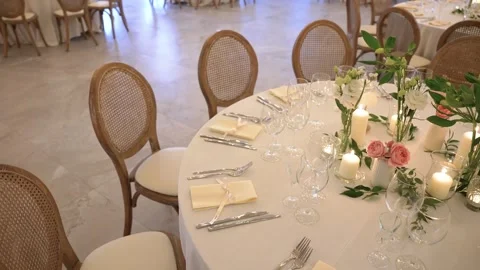Elegant wedding reception table setting with floral centerpieces and burnin.. Stock Footage 337471307