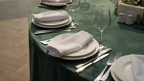 Elegant wedding reception table setting with neatly arranged plates and glasses Stock Footage 338070041