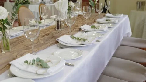 Elegant wedding reception table setting with floral decor and glassware Stock Footage 339458118
