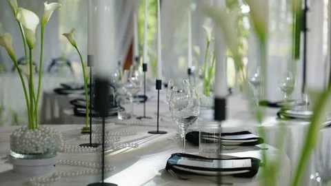 Elegant wedding reception table setting with floral arrangements and candles Stock Footage 339458219