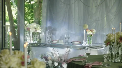 Elegant wedding reception table setting with floral arrangements and candles Stock Footage 339458318