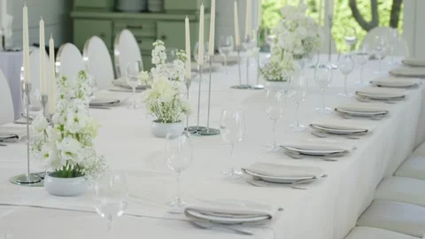 Elegant wedding reception table setting with floral arrangements and candles Stock Footage 339458348