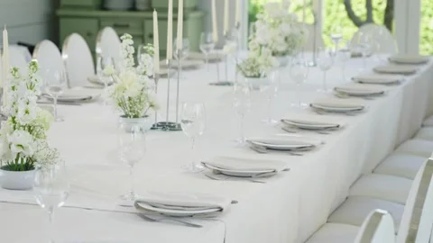 Elegant wedding reception table setting with white flowers and candles Stock Footage 339458417