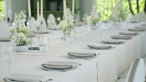 Elegant wedding reception table setting with white flowers and candles Stock Footage 339458593