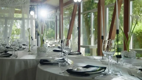 Elegant wedding reception table setting with floral arrangements and glassware Stock Footage 339458701