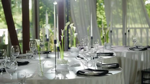 Elegant wedding reception table setting with floral arrangements and candles Stock Footage 339458798