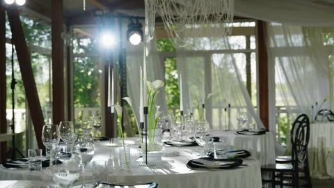 Elegant wedding reception table setting with floral arrangements and glassware Stock Footage 339458870